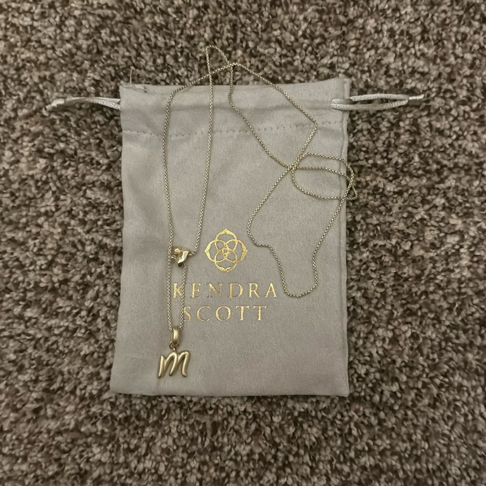 Kendra Scott gold necklace with “m” charm
